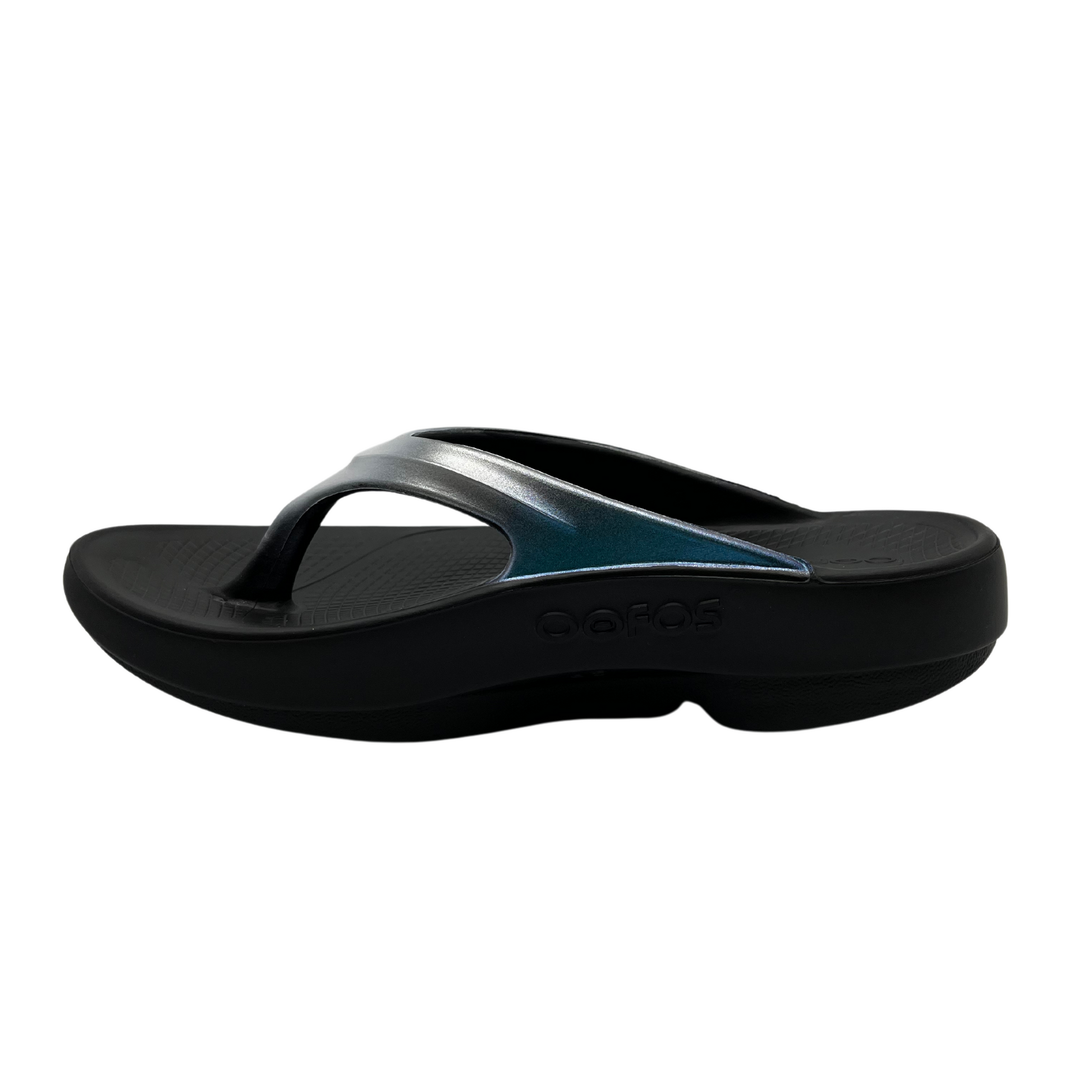 Left facing view of foam, thong strapped sandals with iridescent finish on straps