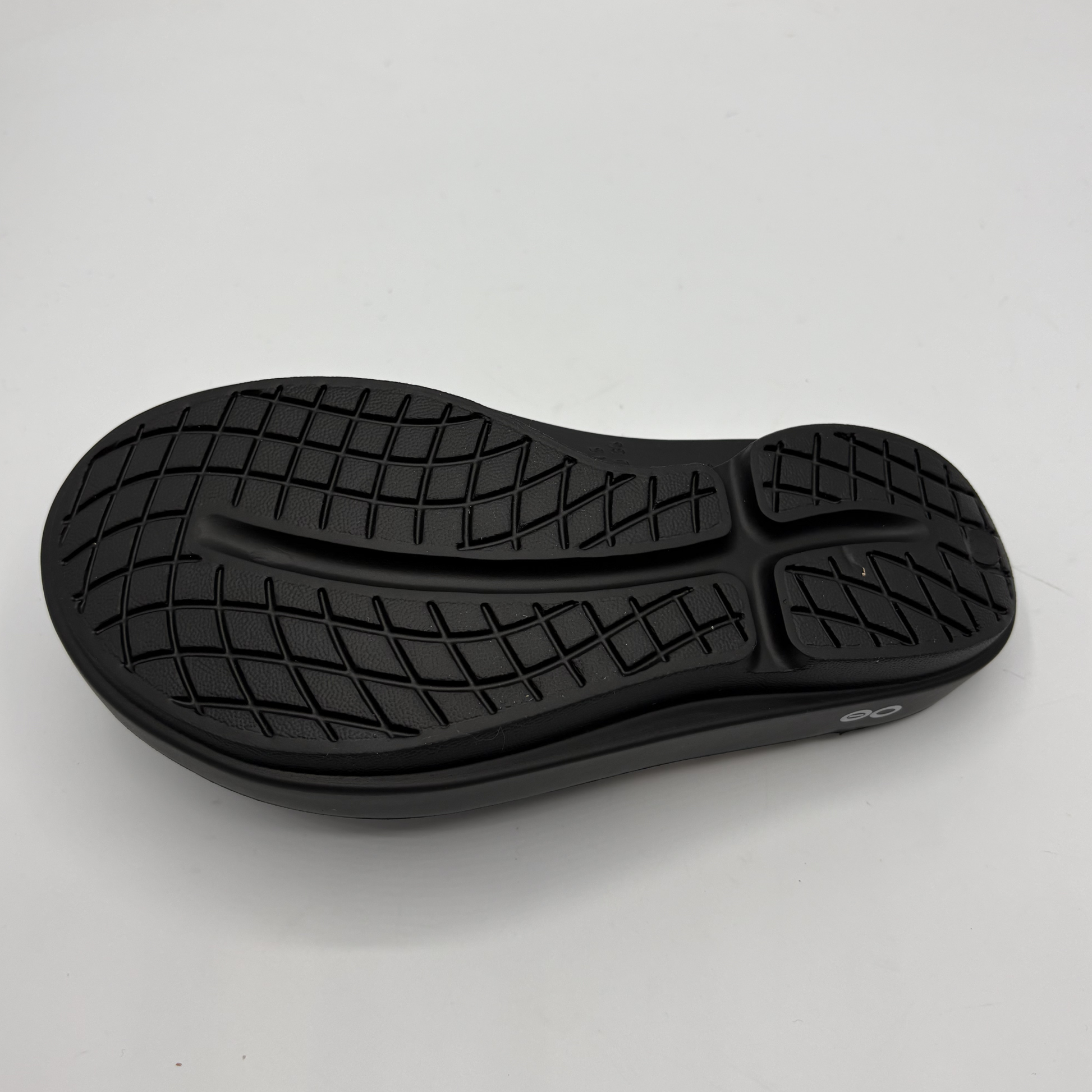Black shoe sole on a light gray background