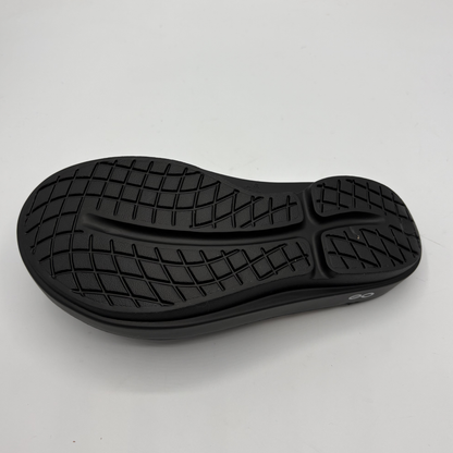 Black shoe sole on a light gray background