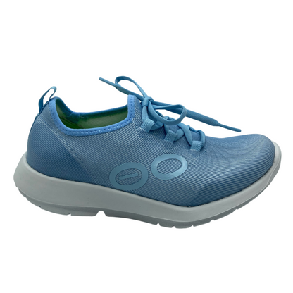 Right facing view of flexible blue sneaker with white sole. 