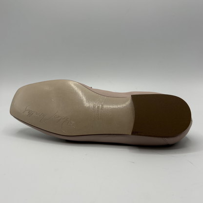 Bottom view of a leather loafer with a gold accent