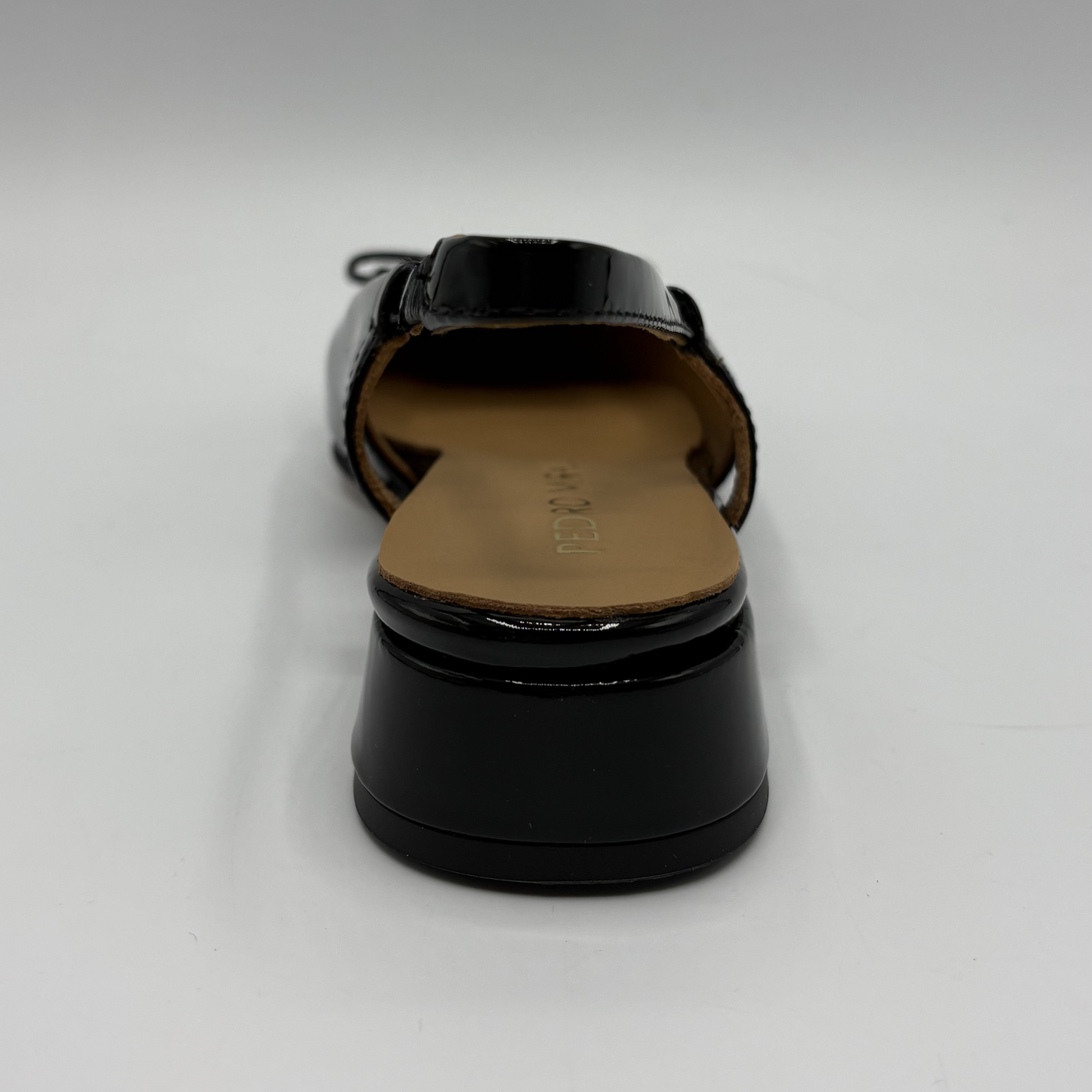 Back  view of a black patent leather slingback shoe with a wrapped heel