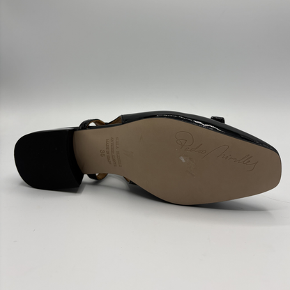 Bottom view of a black patent leather slingback shoe with a wrapped heel