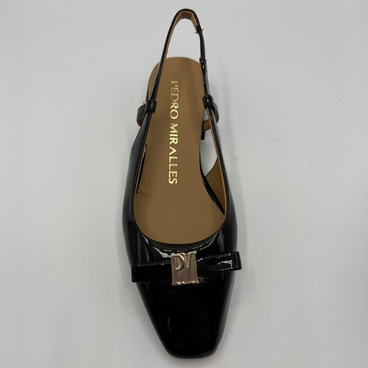 Top  view of a black patent leather slingback shoe with a wrapped heel