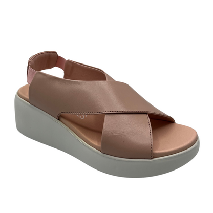 45 degree angled view of leather crisscross strap sandal with elastic slingback strap and white wedge heel