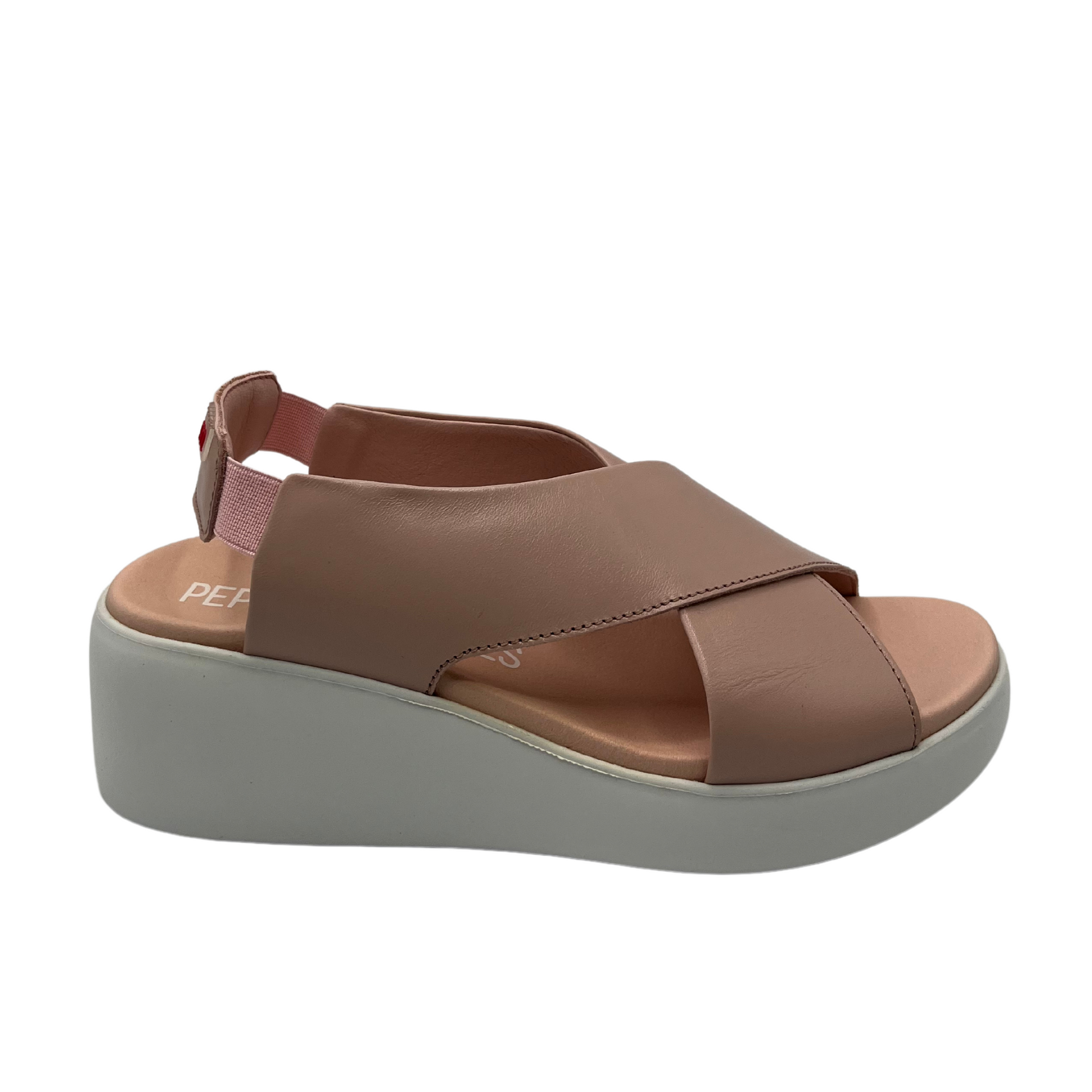 Right facing view of leather wedge shoe with criss cross straps and elastic slingback strap