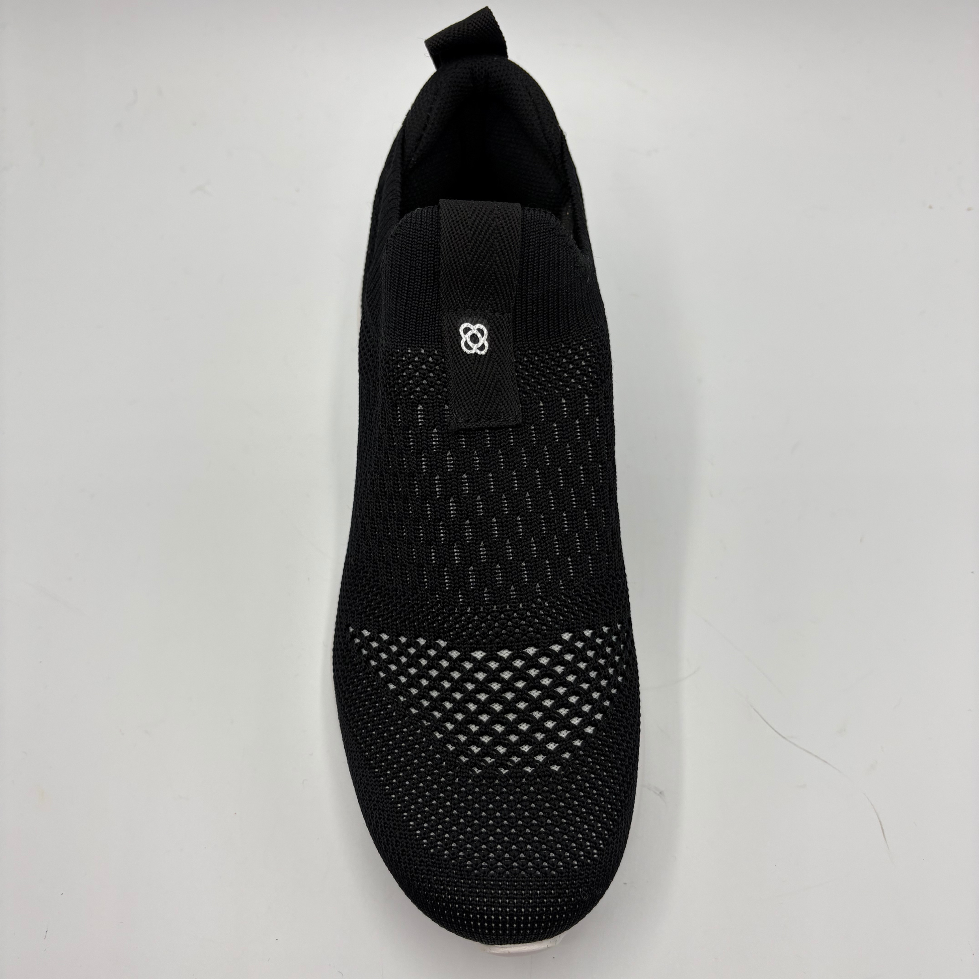 Black sock shoe on a light gray background