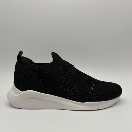 Black slip-on sneaker with white sole on a light gray background