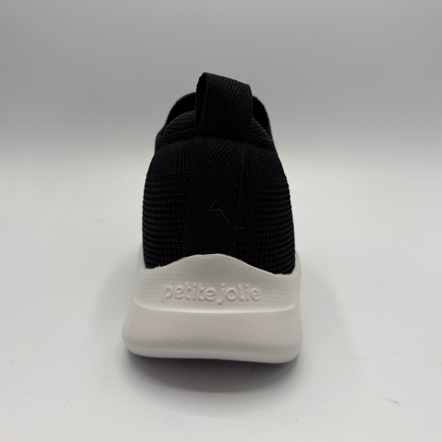Black sock with white sole on a gray background