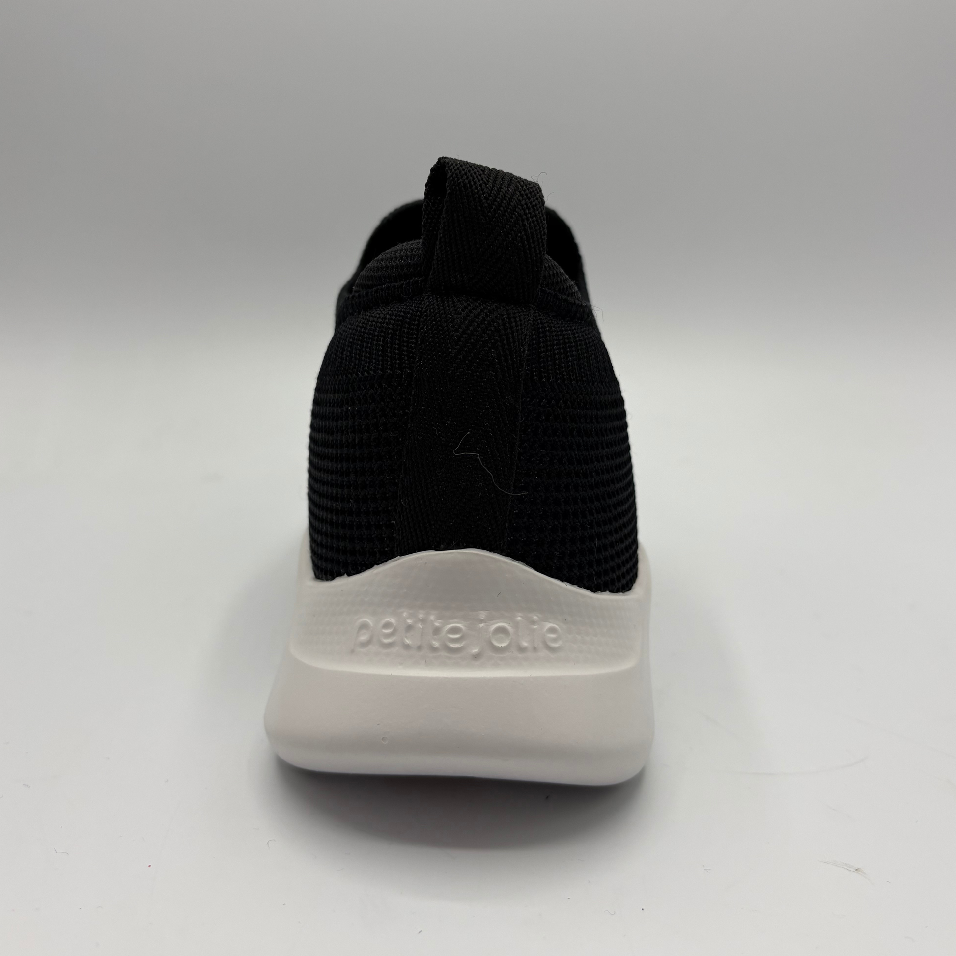 Black sock with white sole on a gray background