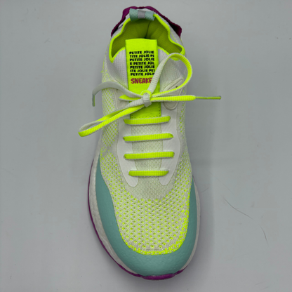 Sneaker with bright yellow laces and sole on a gray background