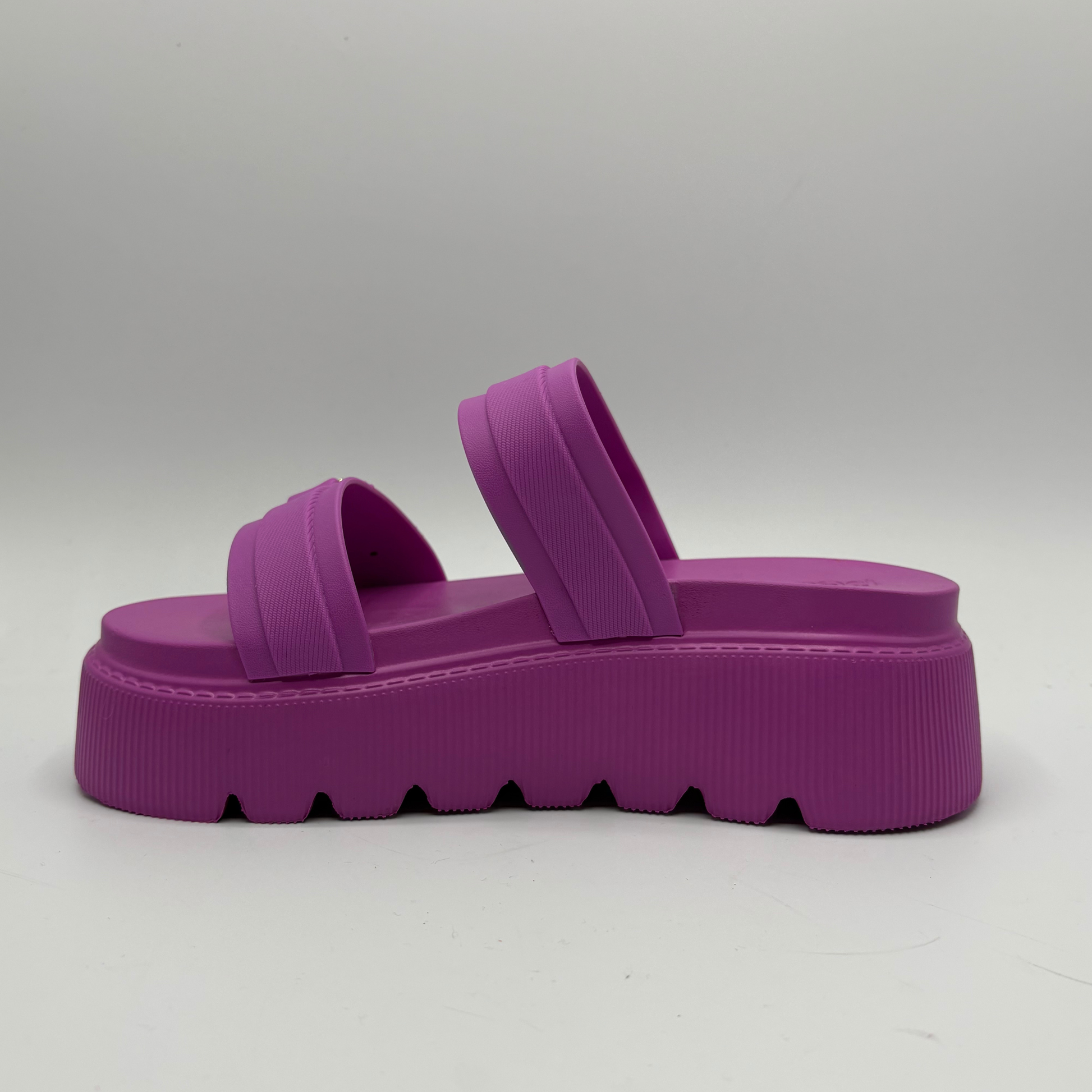 Purple platform sandal on a gray background