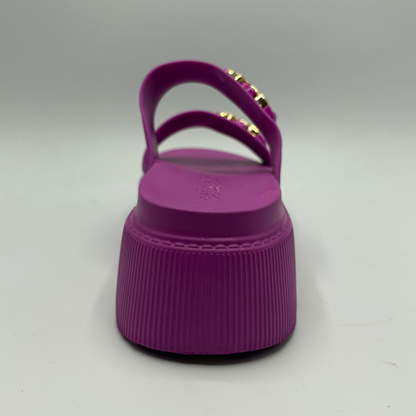 Purple sandal with a platform sole on a gray background