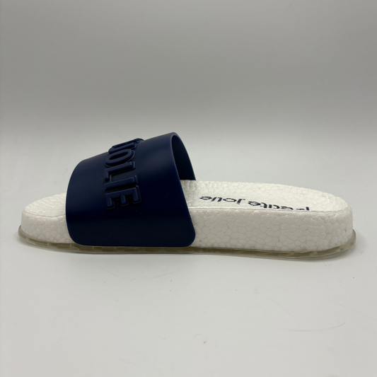 Navy slide sandal with white sole on a gray background