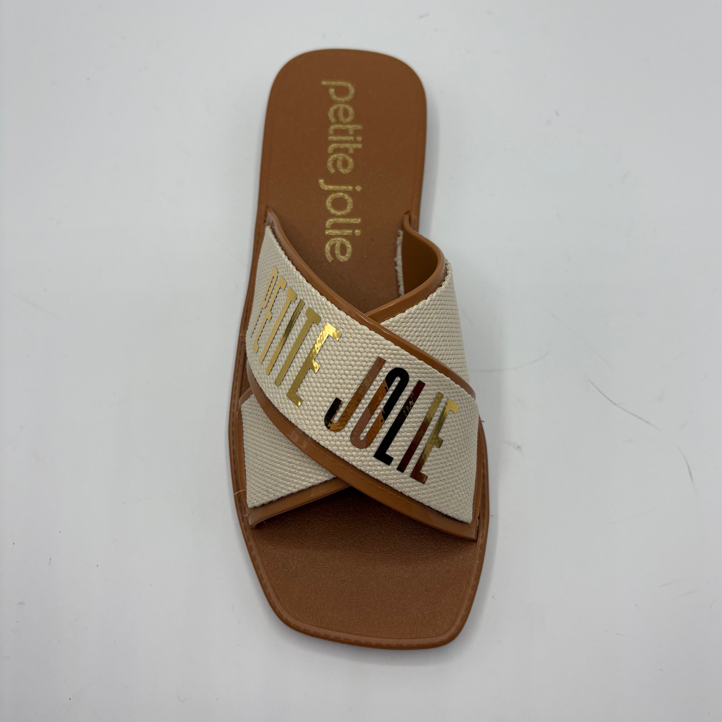 Brown sandal with 'petite jolie' branding on a white background