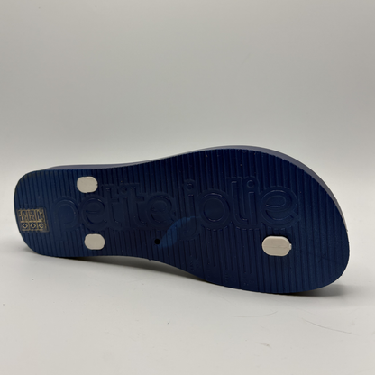 Blue sandal sole with brand logo on a gray background