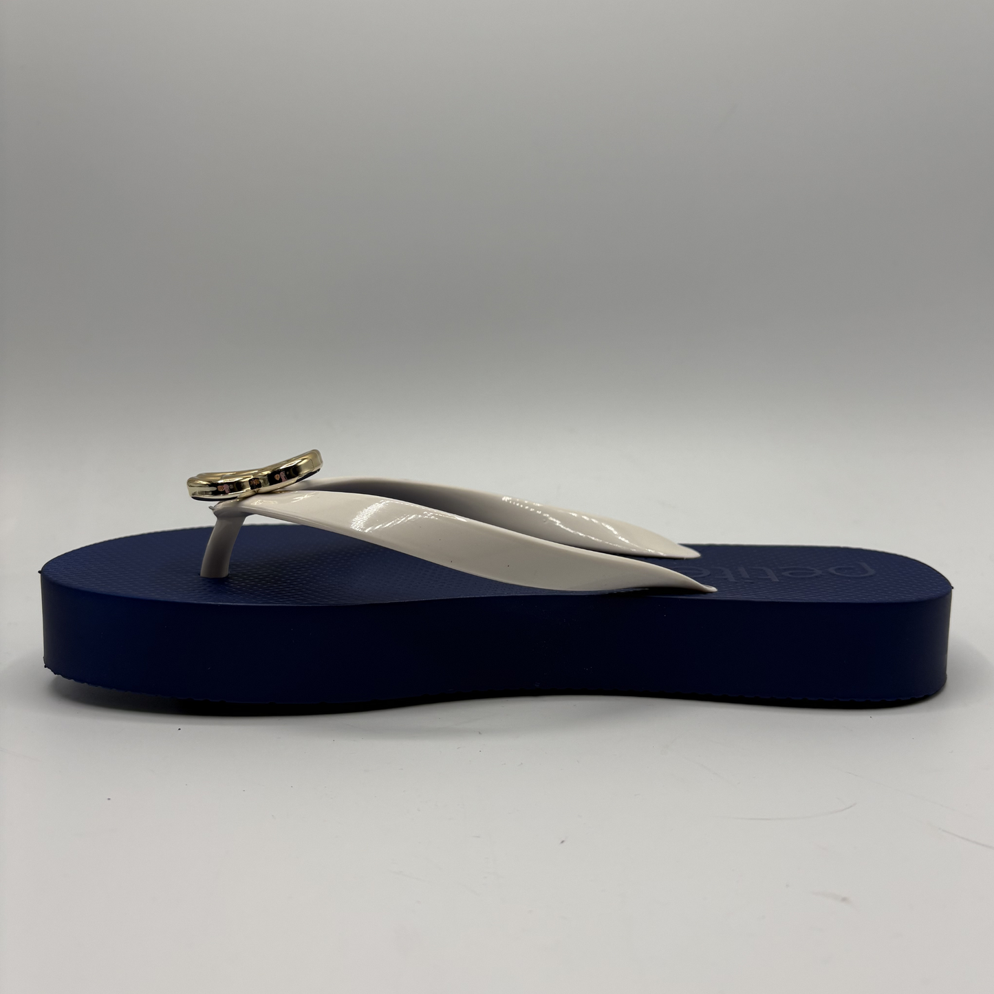 Flip-flop sandal with a blue sole and white strap on a gray background