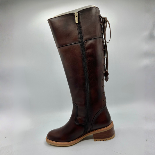 Brown knee-high boot with a white interior on a light gray background