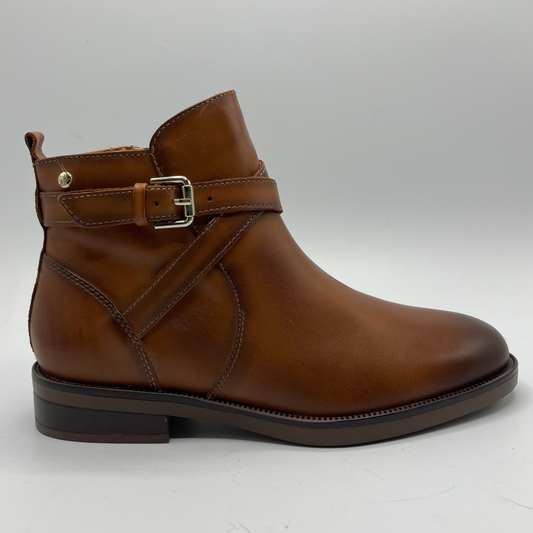 Brown leather boot with a buckle on a light gray background