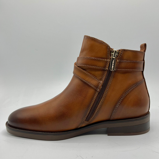 Brown leather boot with a zipper on a white background