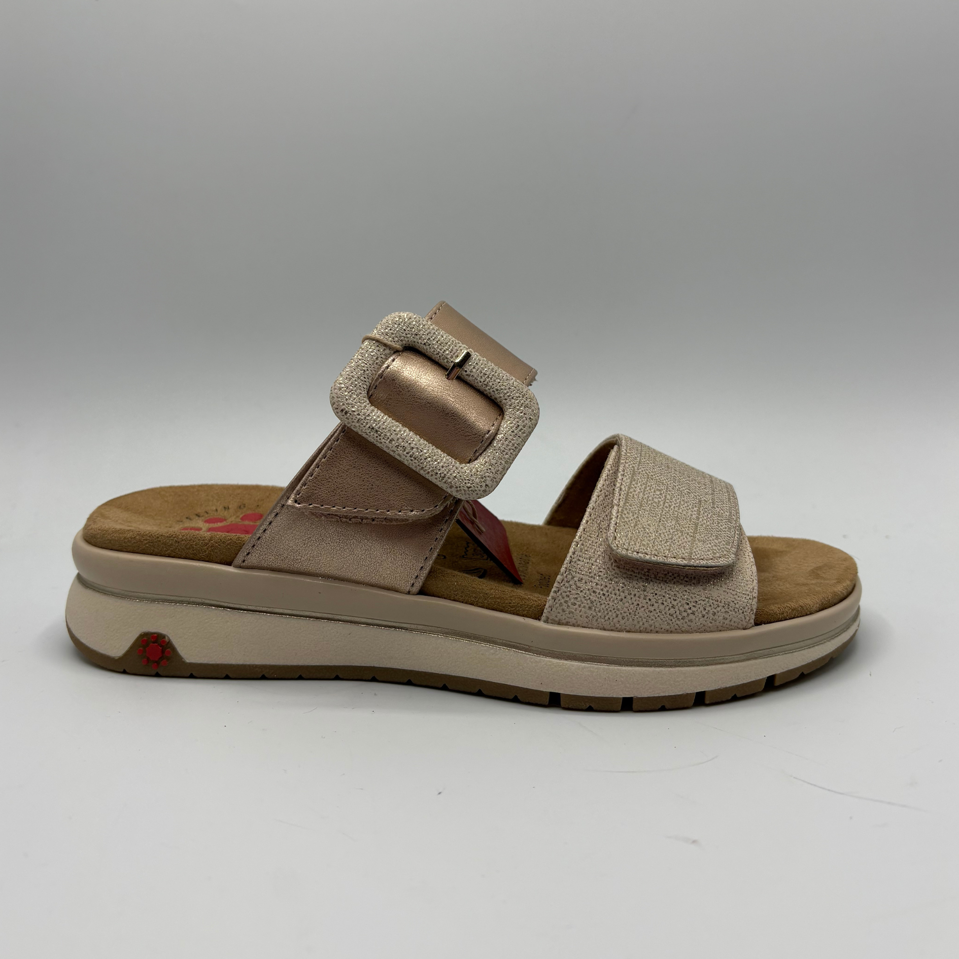 Beige sandal with a buckle on a white background