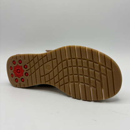 Brown sole of a shoe with red accents on a white background