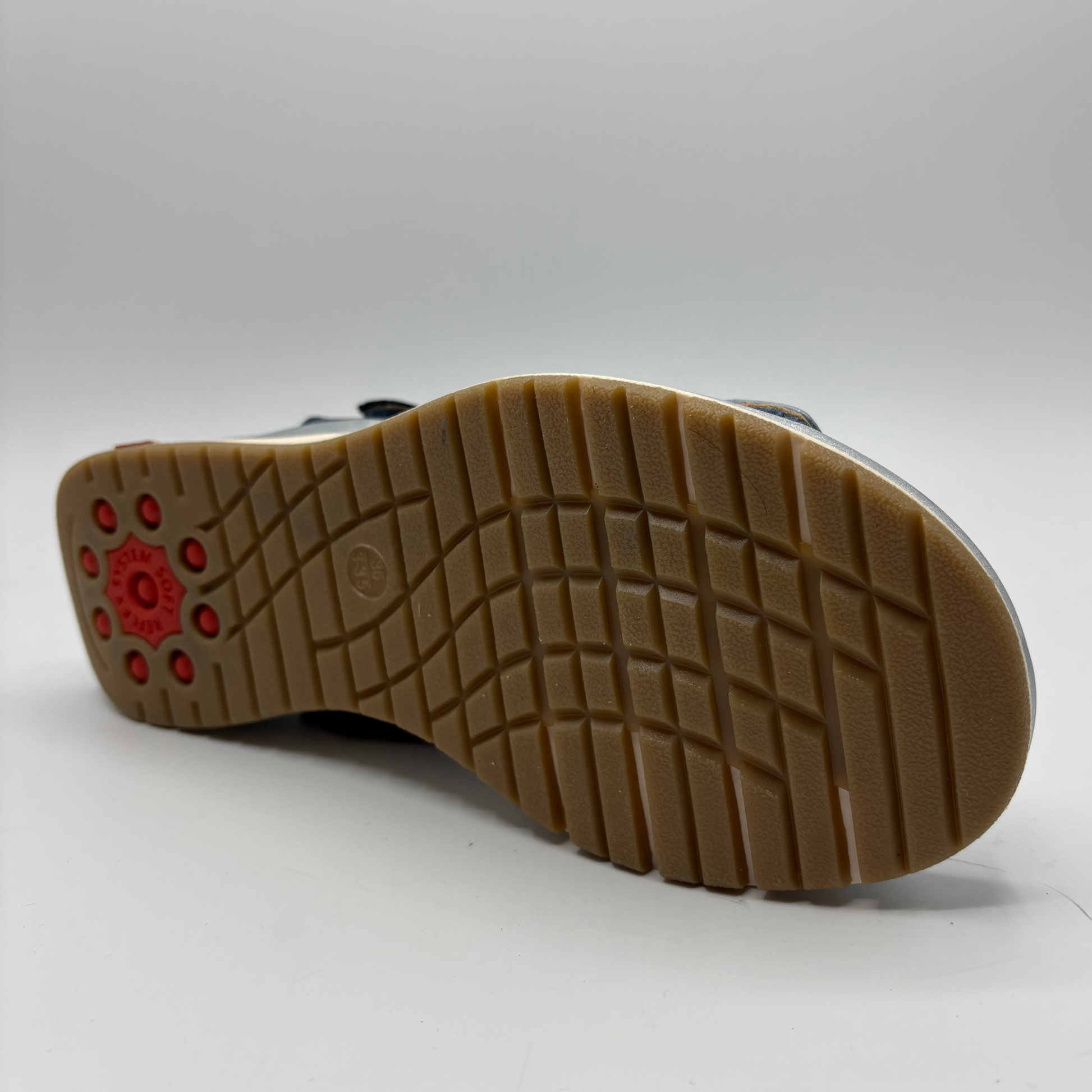 Close-up of a shoe sole with a textured pattern on a white background