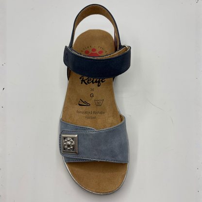 Blue sandal with a decorative buckle on a white background