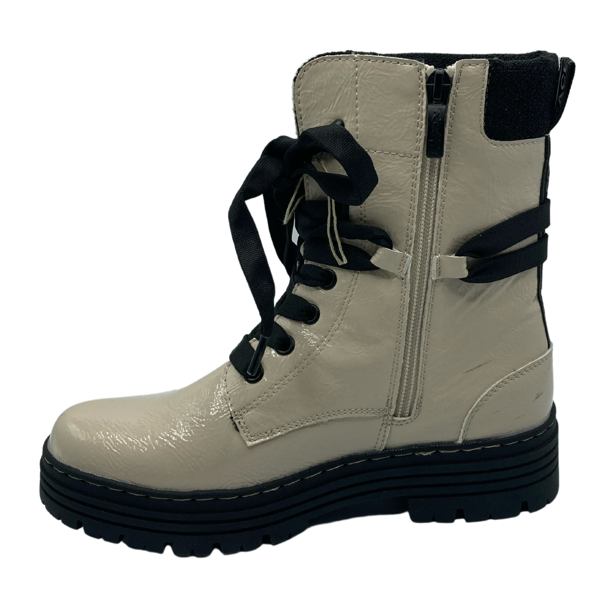 Left facing view of beige patent textile boot with side lace closure and black rubber outsole