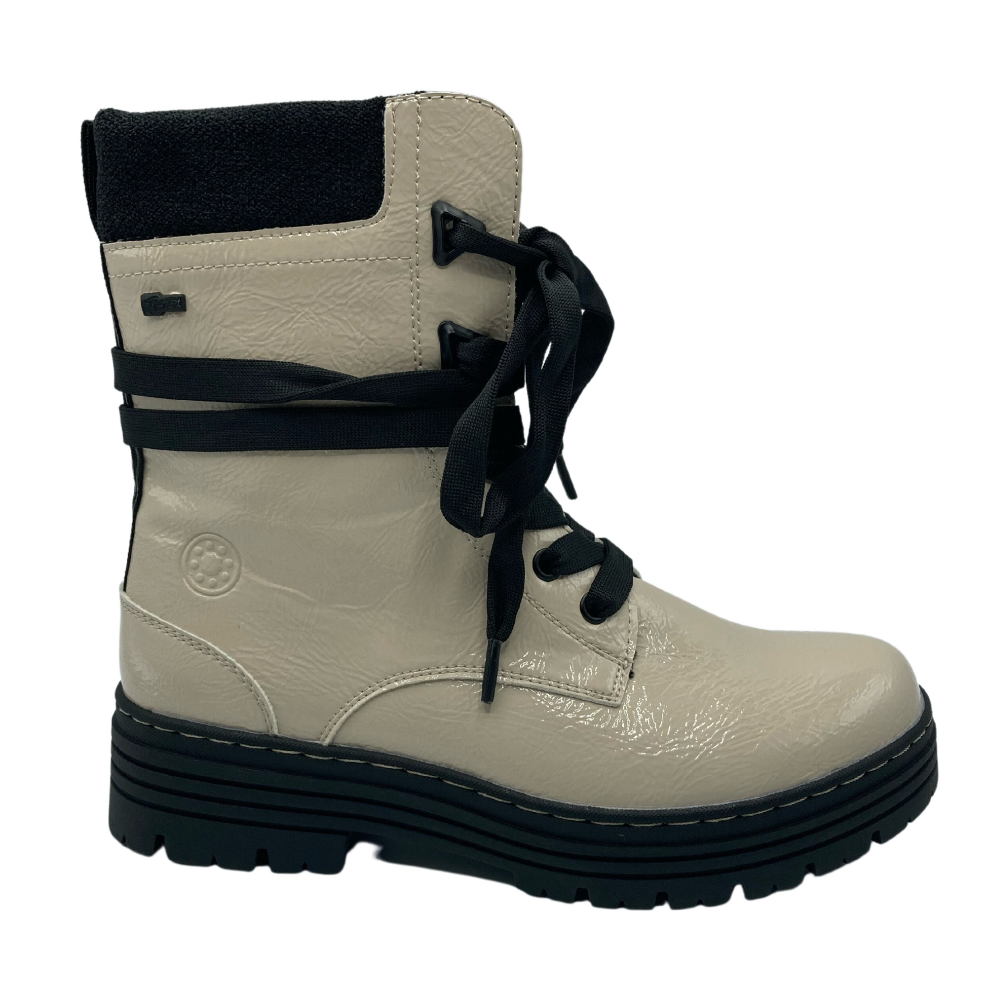 Right facing view of synthetic beige short boot with black laces and black rubber outsole