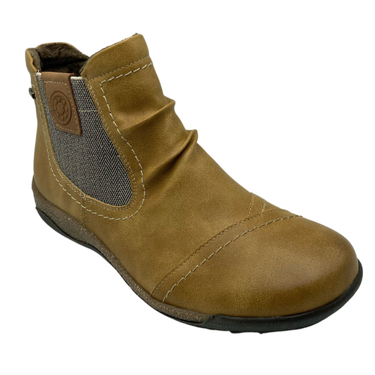 45 degree angled view of mustard short boot with rounded toe and elastic side gore