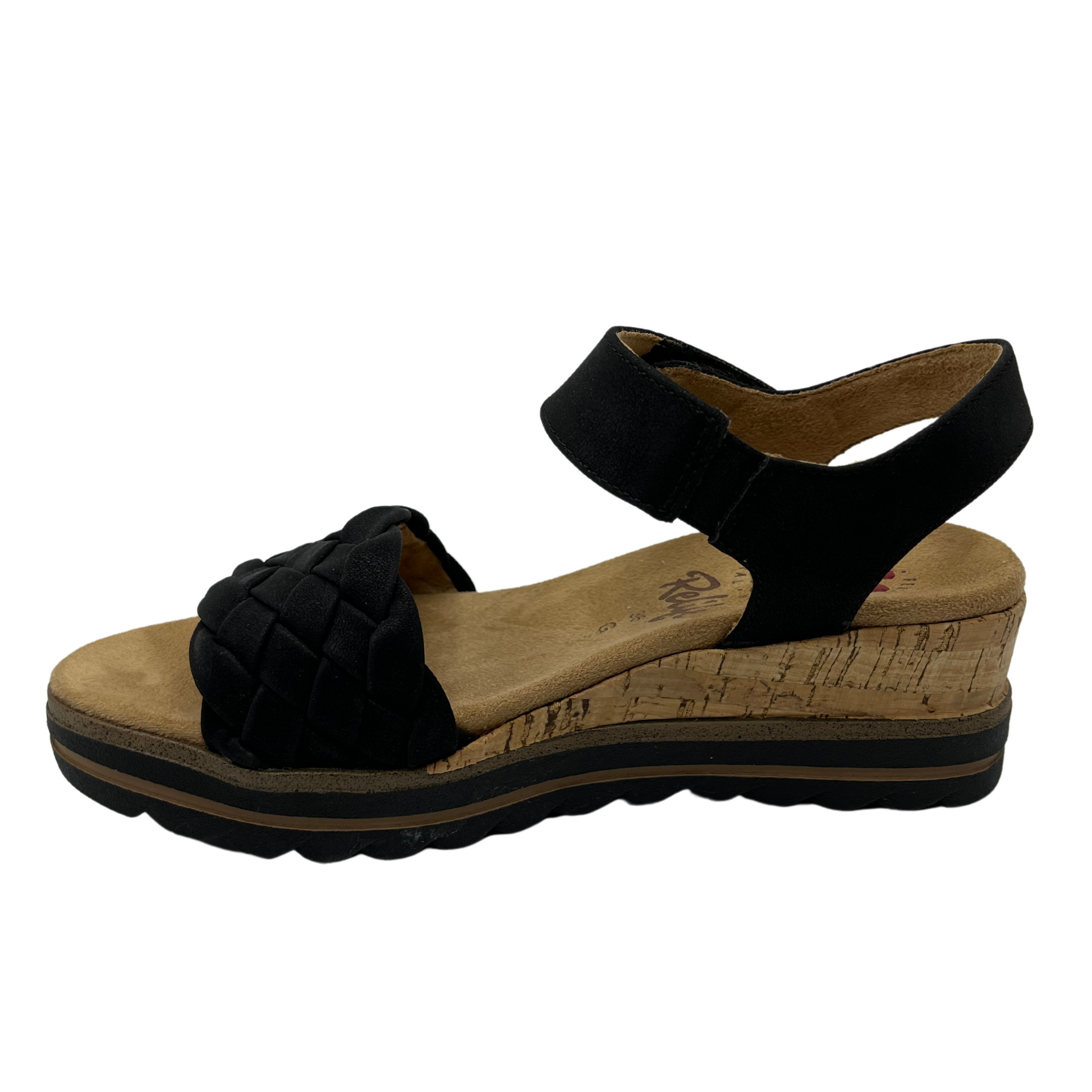 Left facing view of black strapped wedge sandal with velcro strap