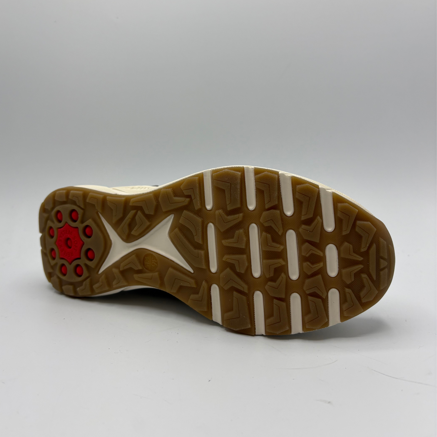 Close-up of a shoe sole with a red circular design on a gray background