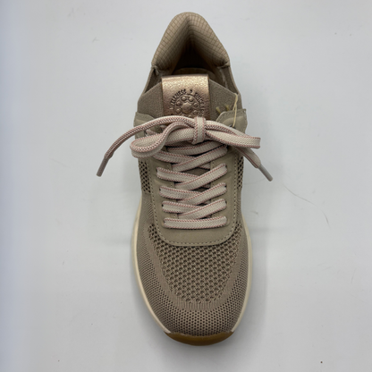 Beige sneaker with laces on a light gray background