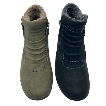 View of a pair of booties side by side. Left one is khaki green with brown fuzzy lining and the right one is black with grey fuzzy lining