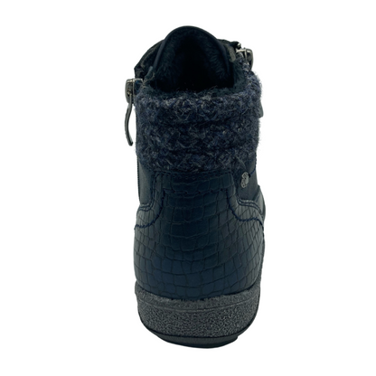 View of the heel of blue ankle boot with grey rubber outsole and fuzzy insulated lining