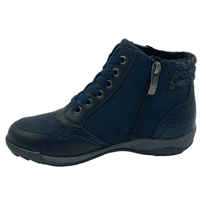 Left facing view of blue ankle boot with side zipper closure and grey rubber outsole