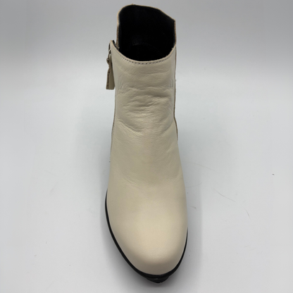 A single cream-colored leather ankle boot with a black sole and black interior, photographed from a top-down angle on a light gray background.