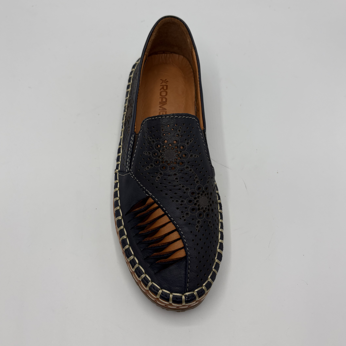 Navy perforated loafer with brown sole on a light gray background