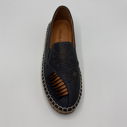 Navy perforated loafer with brown sole on a light gray background