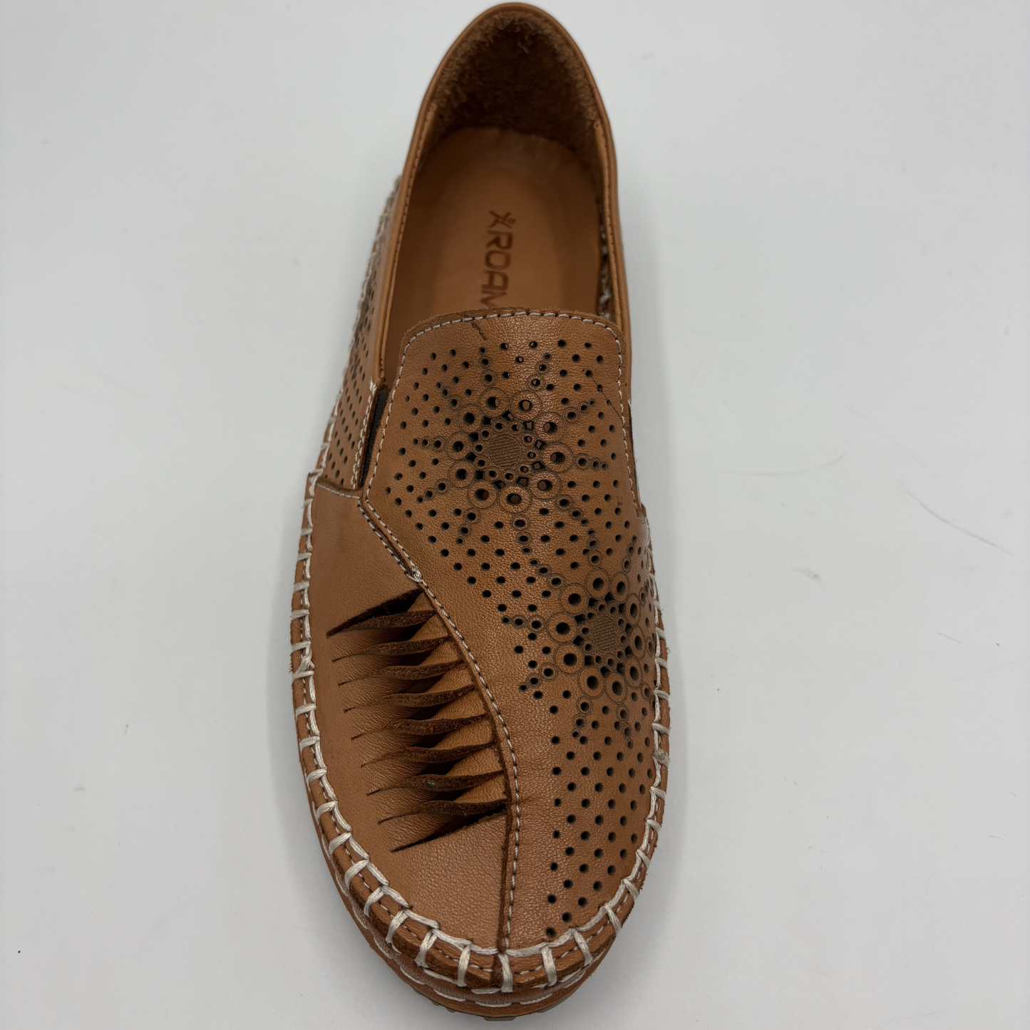 Brown loafer shoe with perforated design on a white background