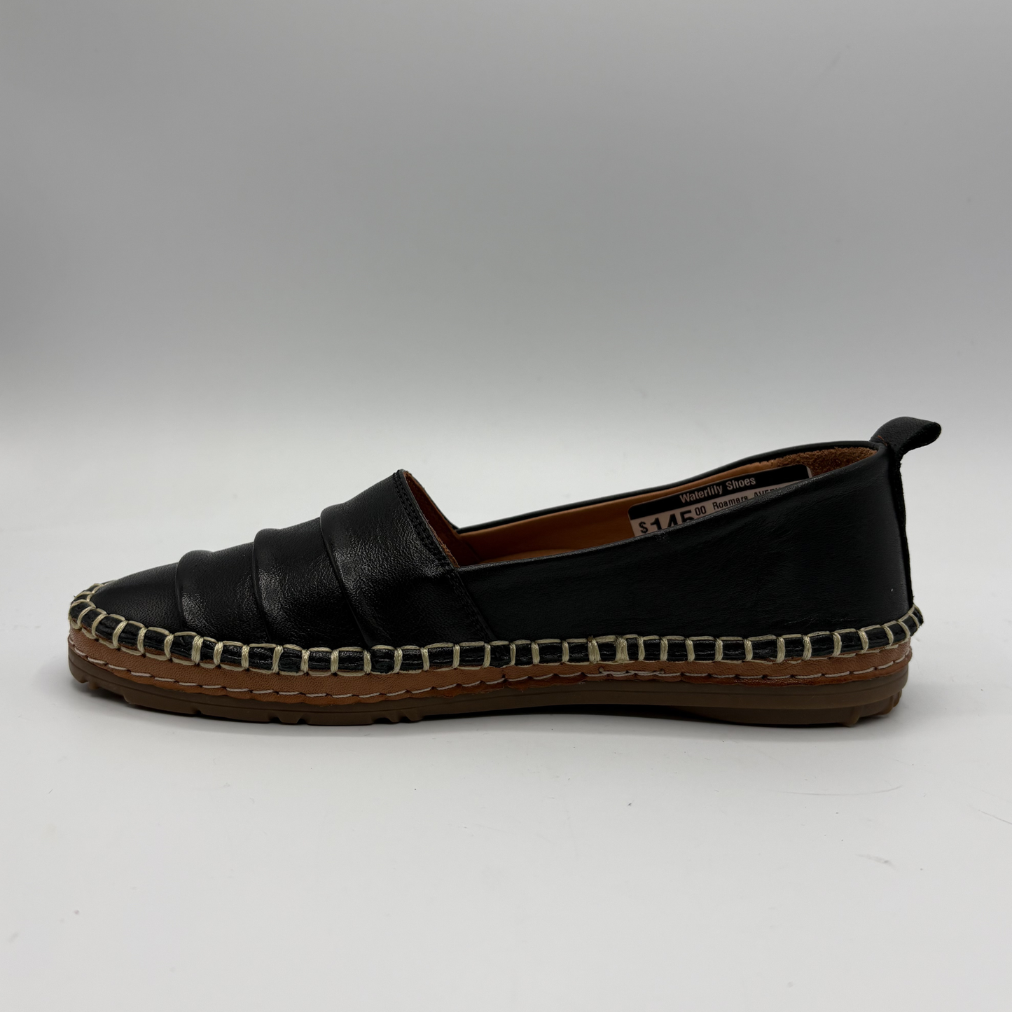 Black espadrille shoe on a white background