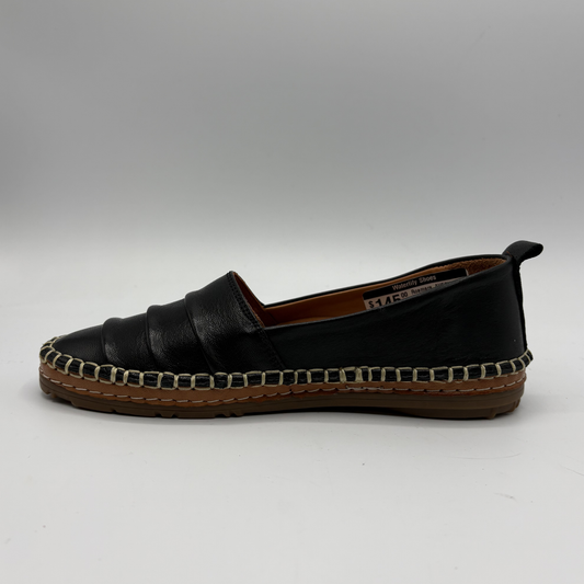 Black espadrille shoe on a white background