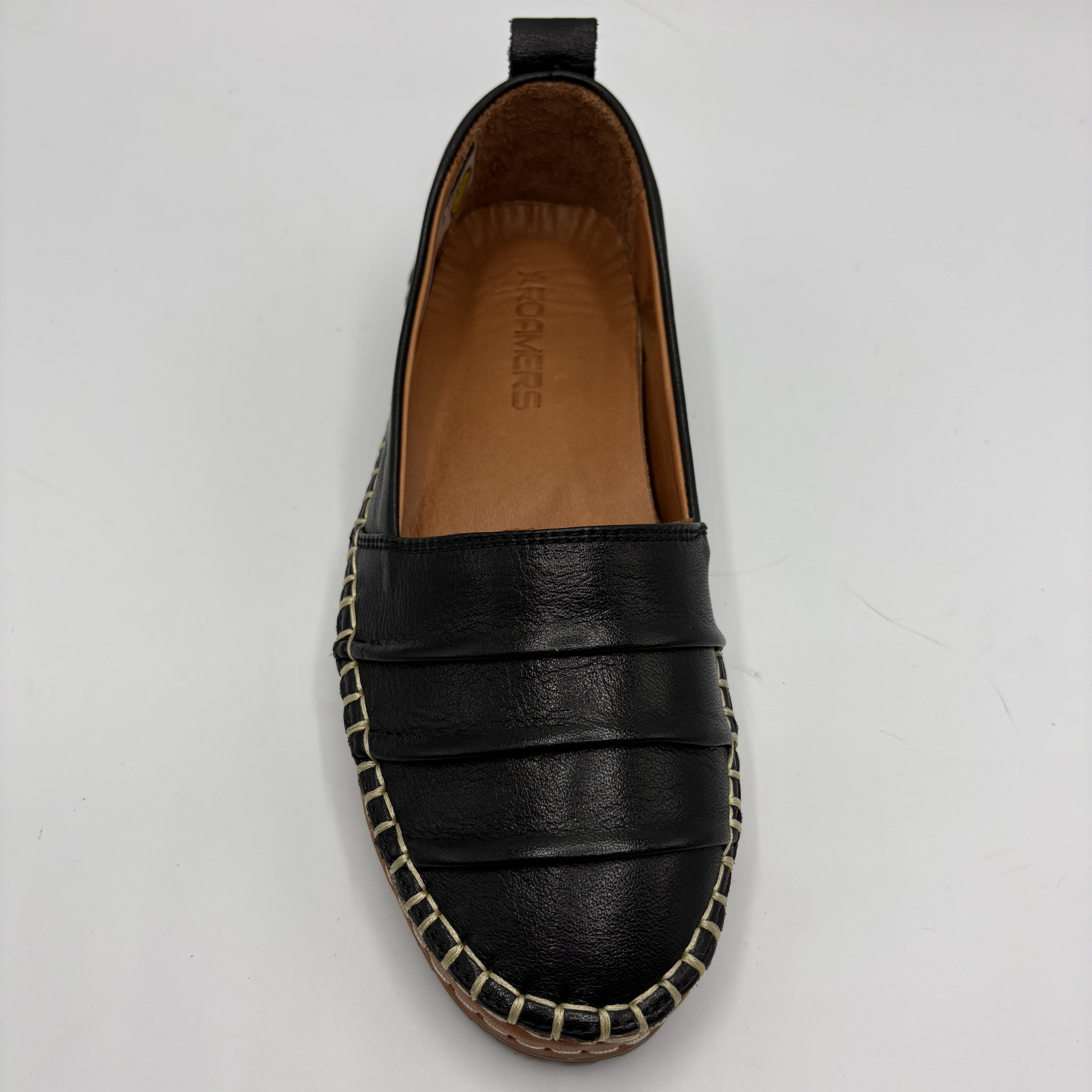 Black leather espadrille shoe on a white background