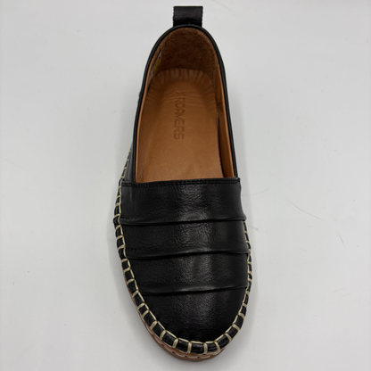 Black leather espadrille shoe on a white background