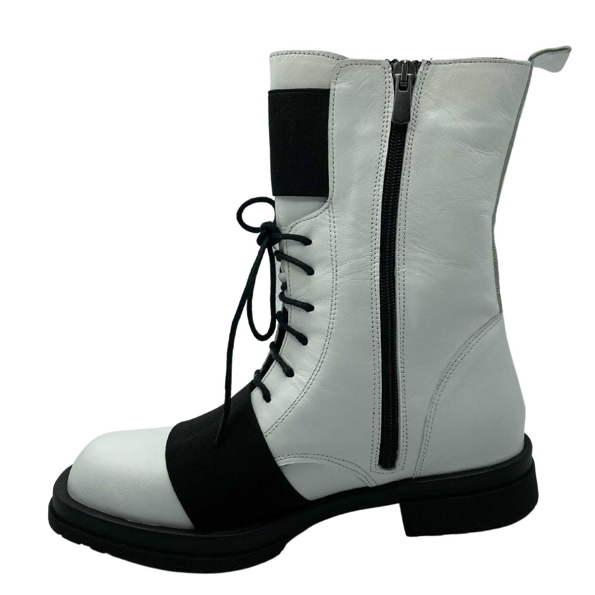 Left facing view of white leather short boot with side zipper closure and black outsole