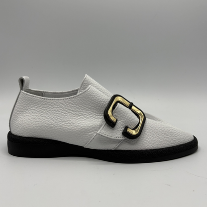 Right facing view of a white leather shoe with a gold buckle