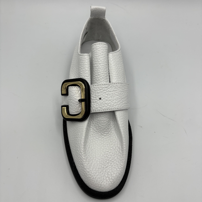 Top  view of a white leather shoe with a gold buckle