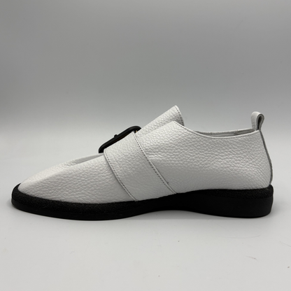 Left view of a white leather shoe with a gold buckle