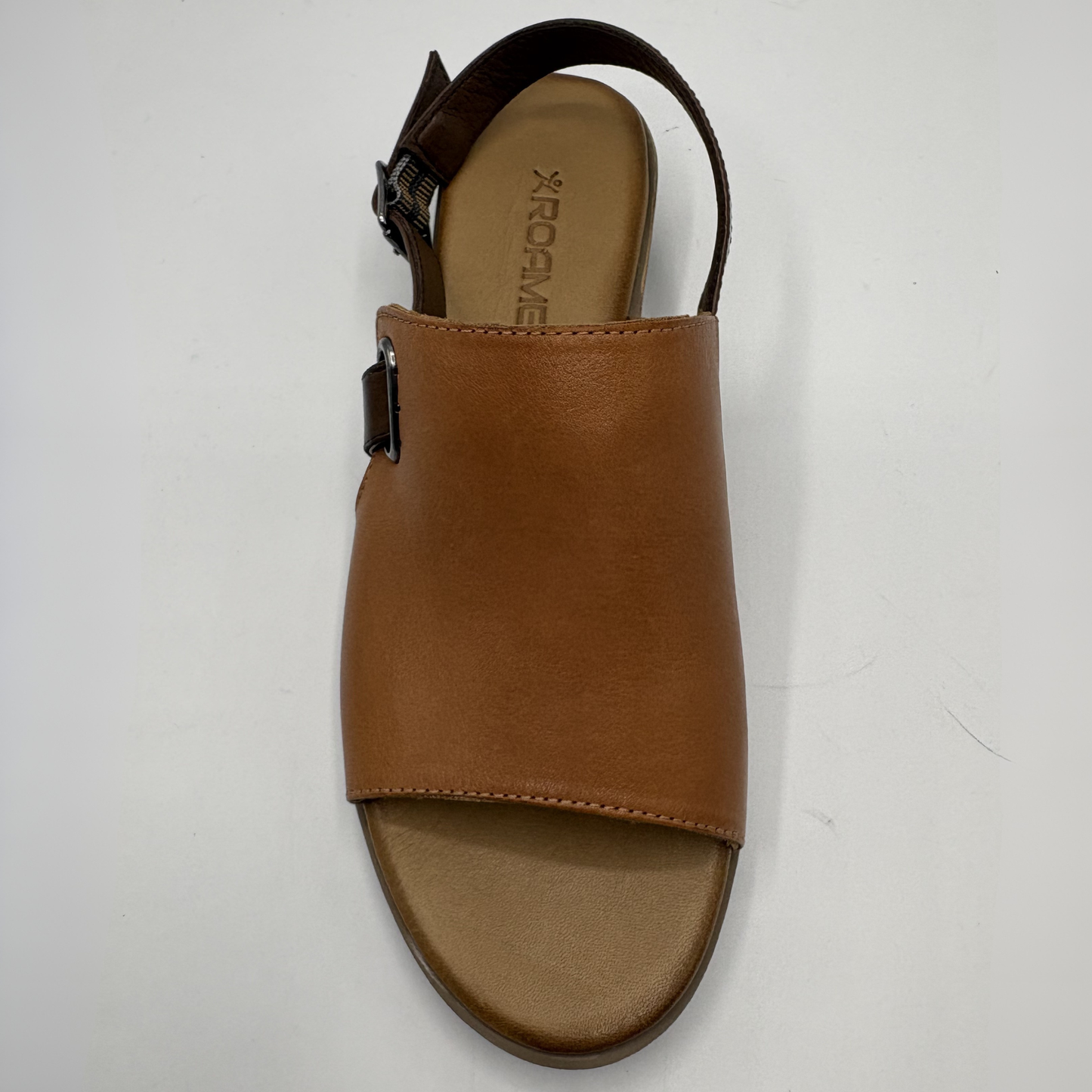 Brown sandal with a visible brand logo on a white background